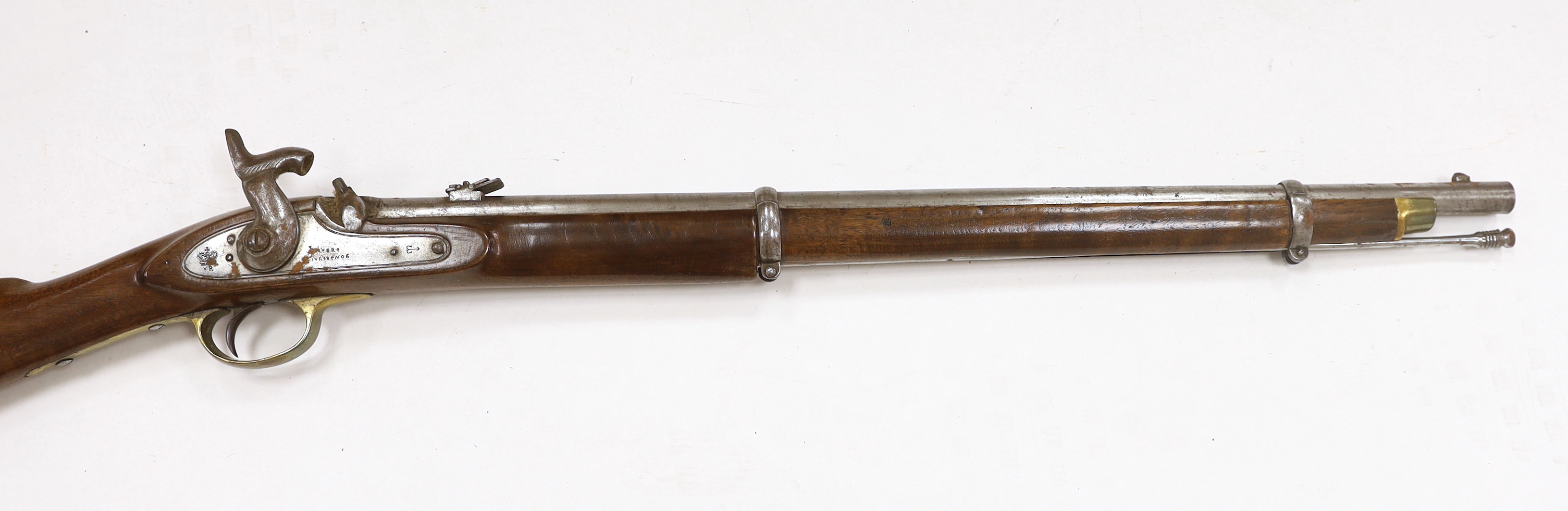 A two band percussion Military carbine of Indian use, regulation brass mounts, fold leaf rear sight, regulation brass mount, lock with Indian marks and also crowned VR, barrel 66.2cm